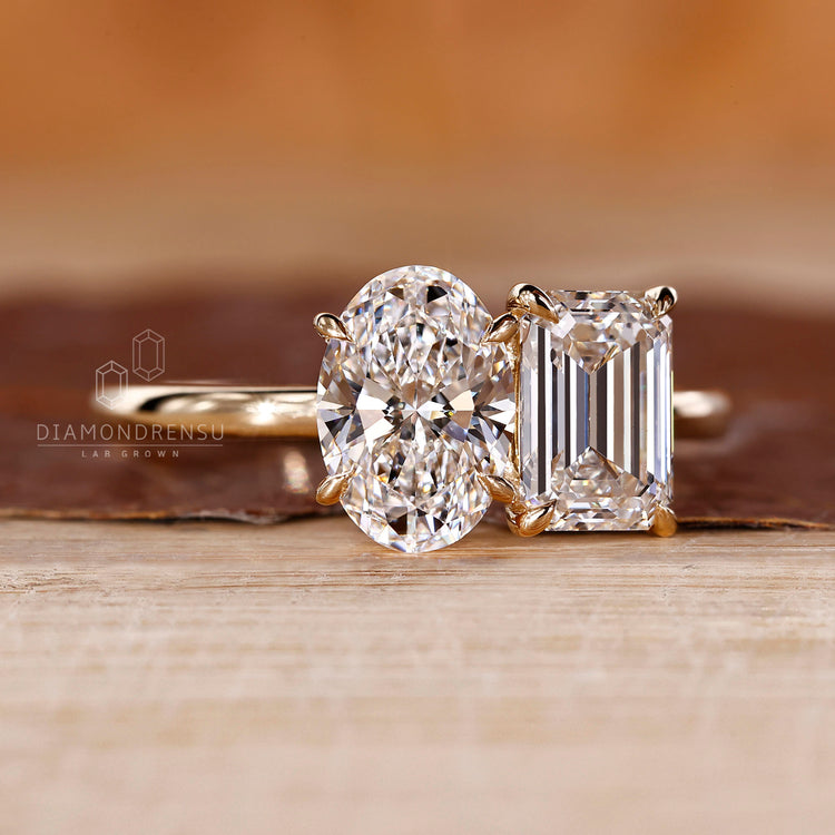 Emerald oval diamond ring claw prong two stone set.
