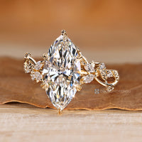 Marquise and round side stone diamond ring.