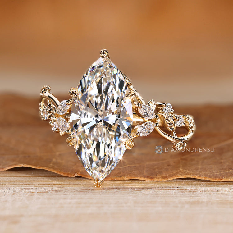 Marquise and round side stone diamond ring.