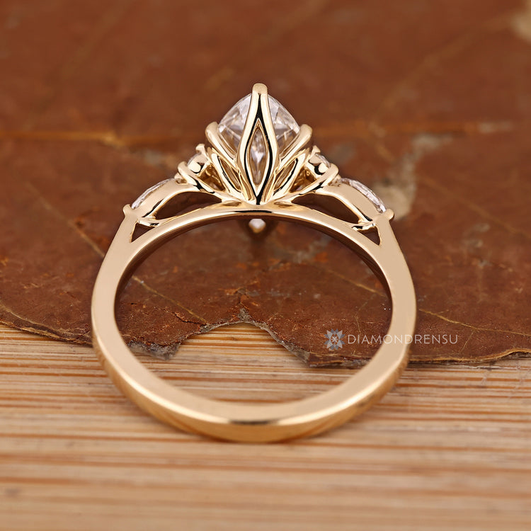 Marquise diamond ring with tapered shank and side stones.