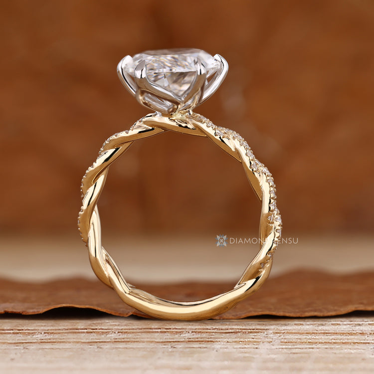 Marquise ring with round diamond pavé details.