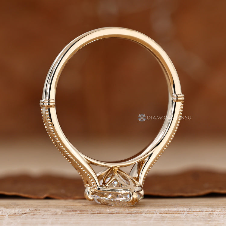 Marquise solitaire diamond ring with milgrain accents.