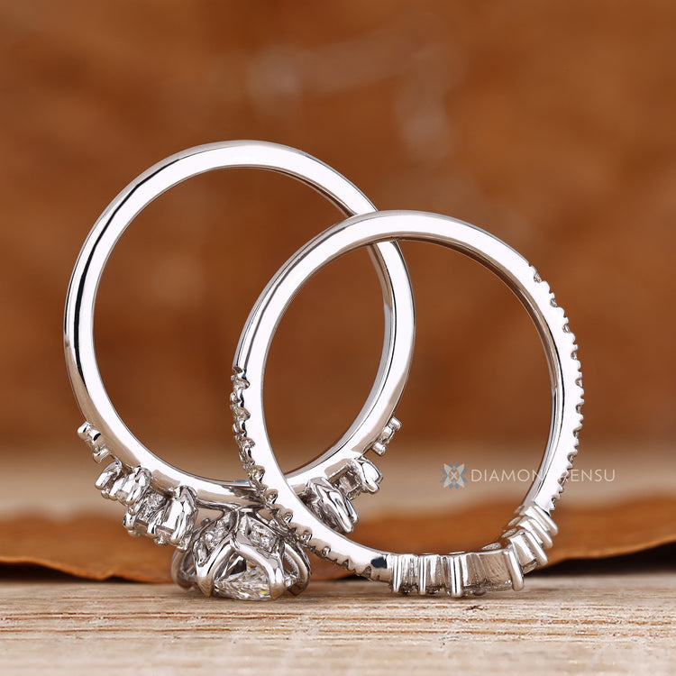 Marquise diamond ring with six claw prongs and side stones.