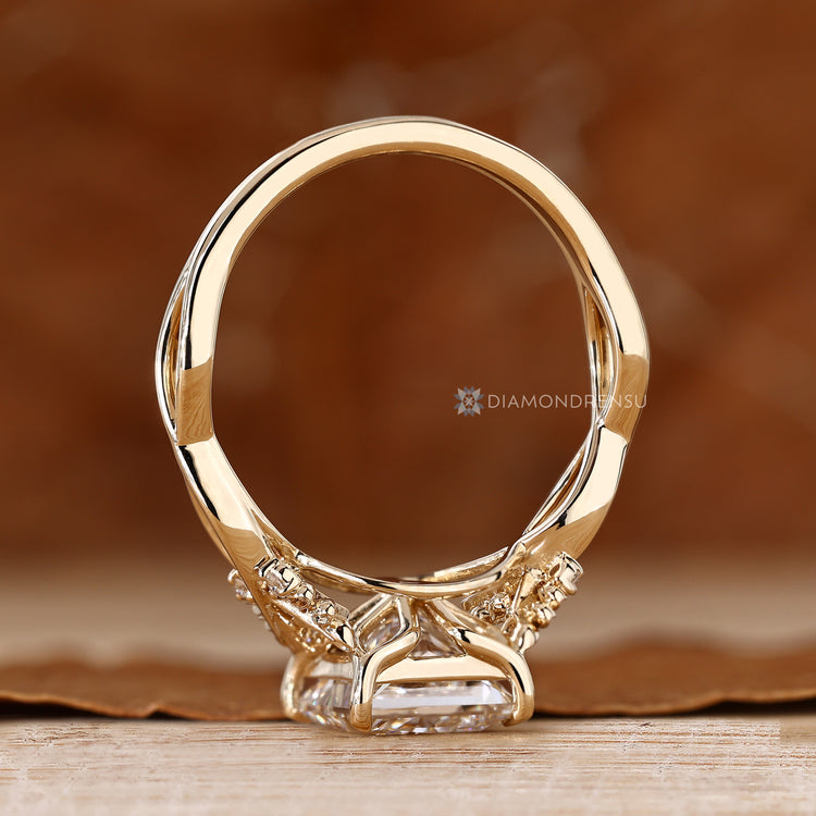 Princess cut ring with twisted shank and round stones.