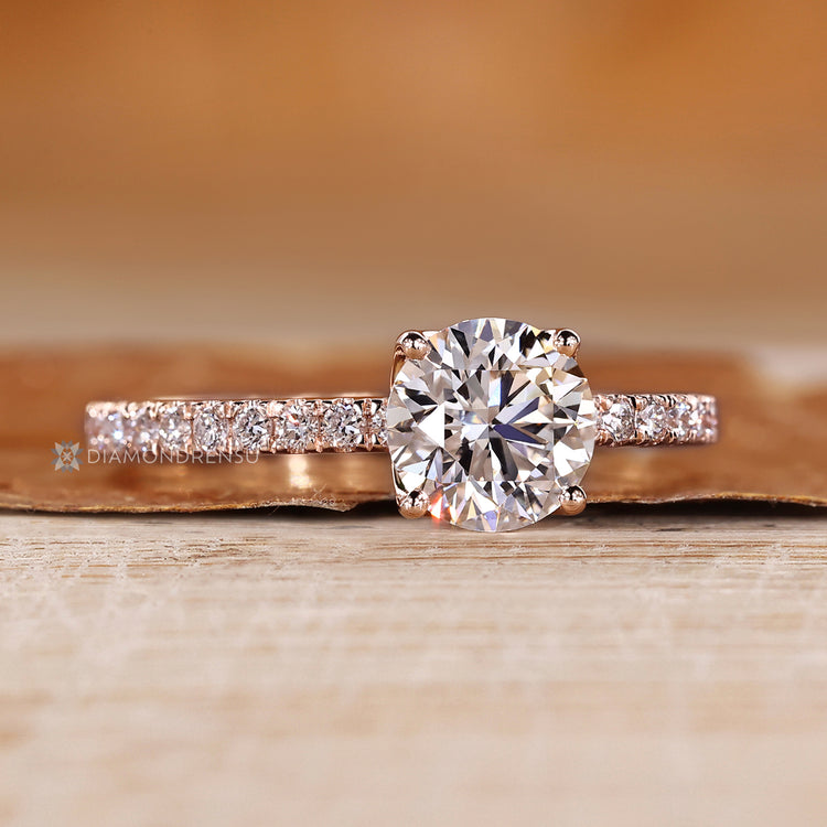 Round diamond ring with pave style and round diamonds.