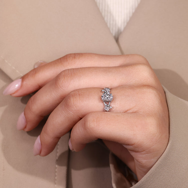 Cluster style oval diamond ring with side stones.
