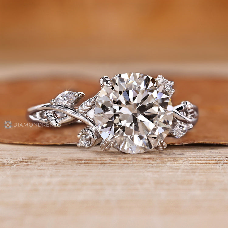 Nature inspired round diamond ring with side stones.