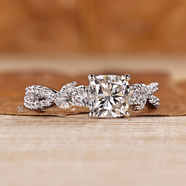 Cushion cut ring twisted pave cluster setting.
