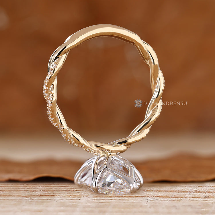Marquise ring with tulip basket and six claw prongs.