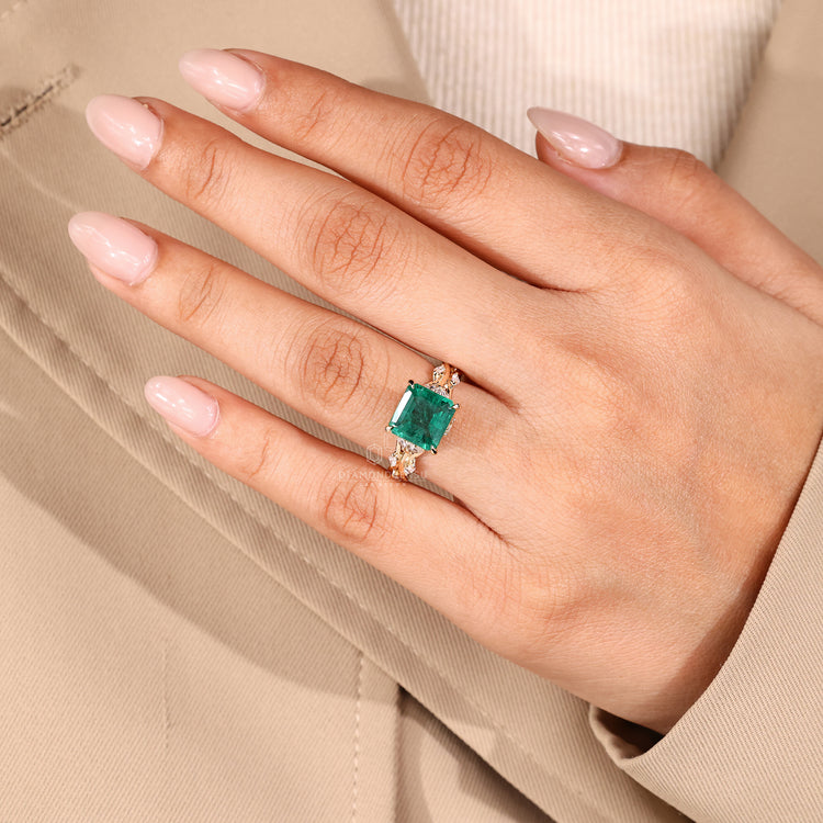 Asscher cut emerald ring prong cluster twisted shank.
