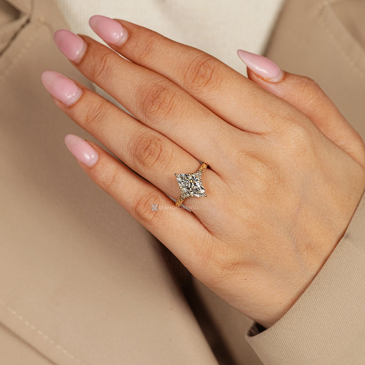 Lab grown marquise diamond ring with six claw prongs.