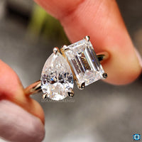 2 stone engagement ring featuring emerald and pear cut stones.