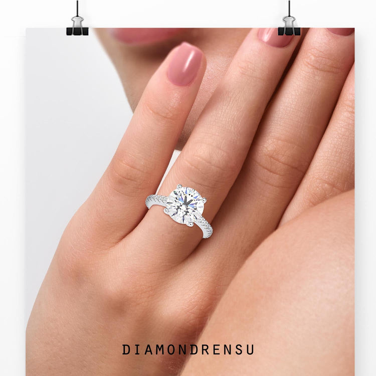 1 carat round diamond ring in a classic cathedral ring setting with pave accents.
