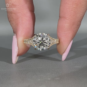 Round diamond ring four claw prong tapered pave style.
