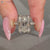 Radiant diamond ring with round diamond pave details.