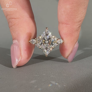 Handmade marquise diamond ring with marquise and round side stones.
