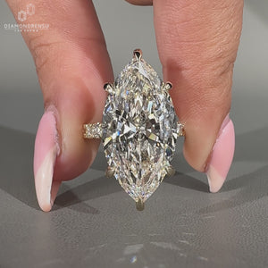 Hidden halo engagement ring featuring marquise cut diamond.