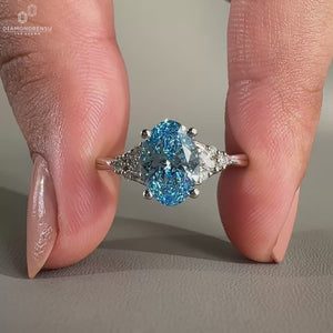 Blue oval engagement ring with white gold engagement ring.
