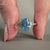 Blue oval engagement ring with white gold engagement ring.
