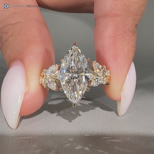 Nature inspired marquise diamond ring with cluster setting.