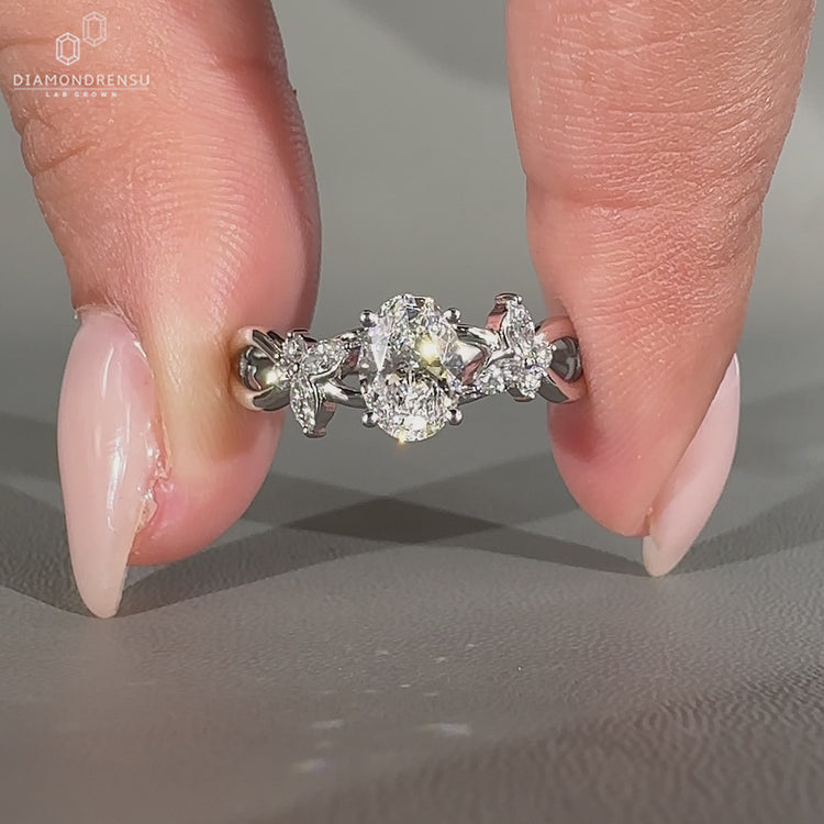 Handmade oval diamond engagement ring in nature inspired style.
