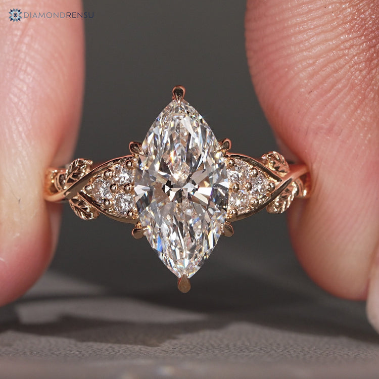 Marquise diamond ring round side stones design.