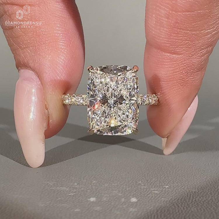 Elongated cushion ring with four claw prong setting.
