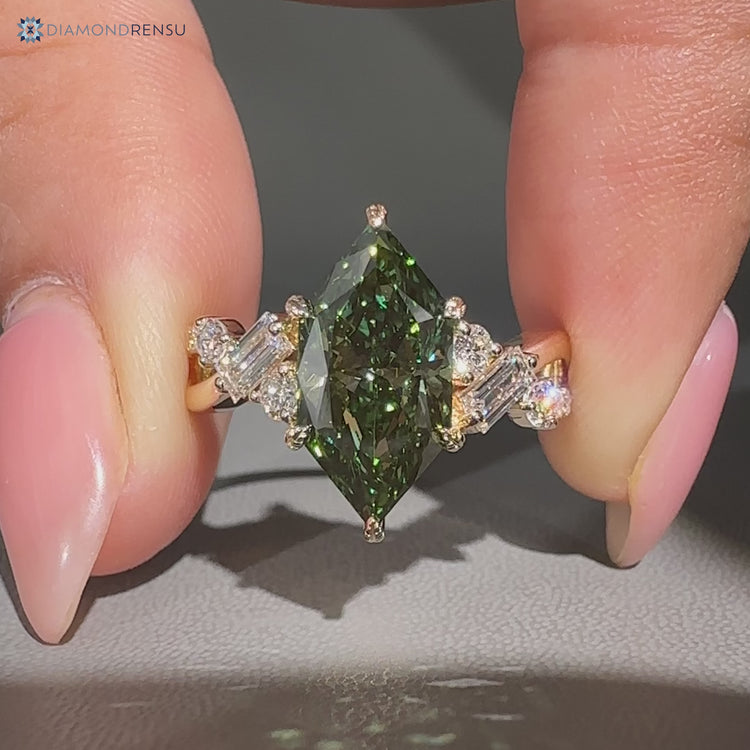 Green diamond ring with baguette and round side stones.