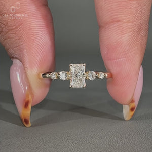 Radiant cut engagement ring with side stones.
