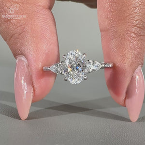 Oval and pear diamond ring with hammer finish shank.
