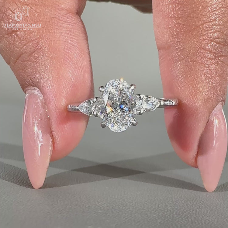 Oval and pear diamond ring with hammer finish shank.
