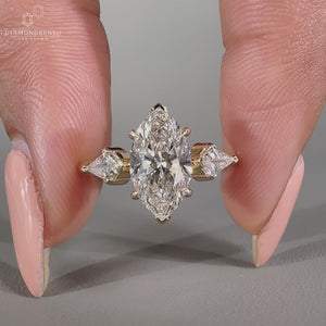 Handmade three stone diamond ring with kite cut side stones.
