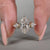 Handmade three stone diamond ring with kite cut side stones.
