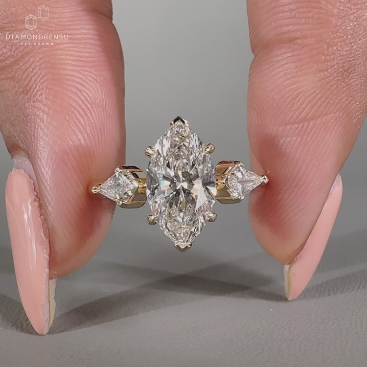 Handmade three stone diamond ring with kite cut side stones.
