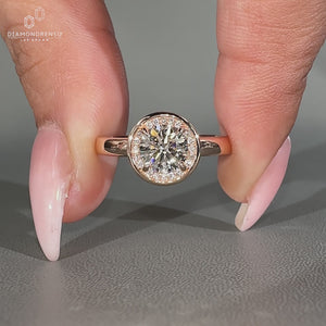 Round diamond ring halo style bezel prong setting.
