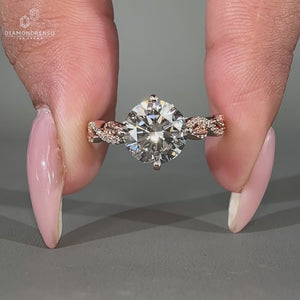 Round cut diamond ring in rose gold with nature inspired design.
