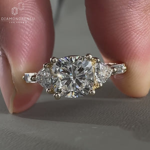 Cushion cut with trillion side stones and 4 prong setting.
