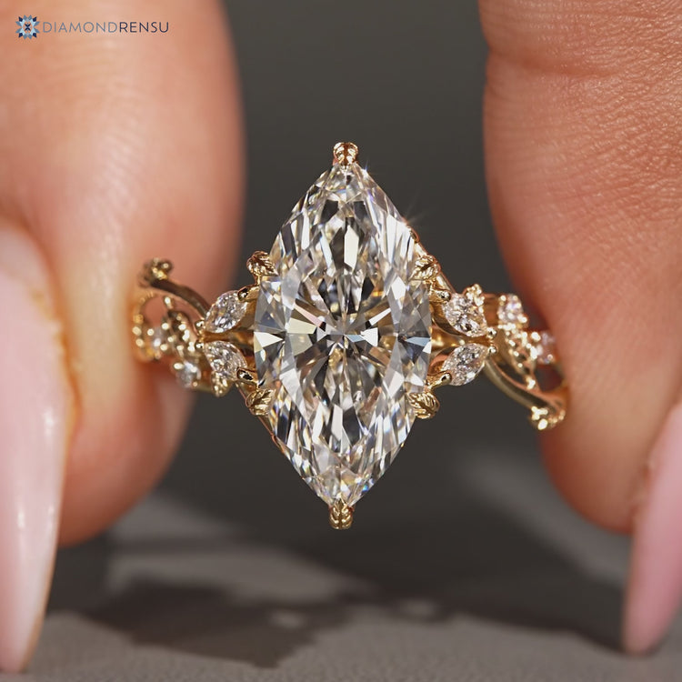 Nature inspired marquise diamond ring with leaf prongs.