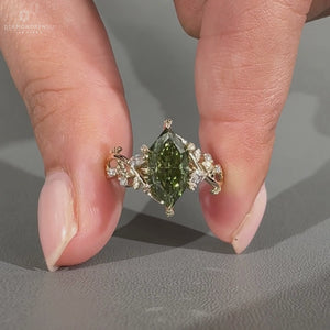Marquise diamond ring green stone cluster leaf prong.