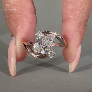Pear diamond engagement ring with bypass setting.
