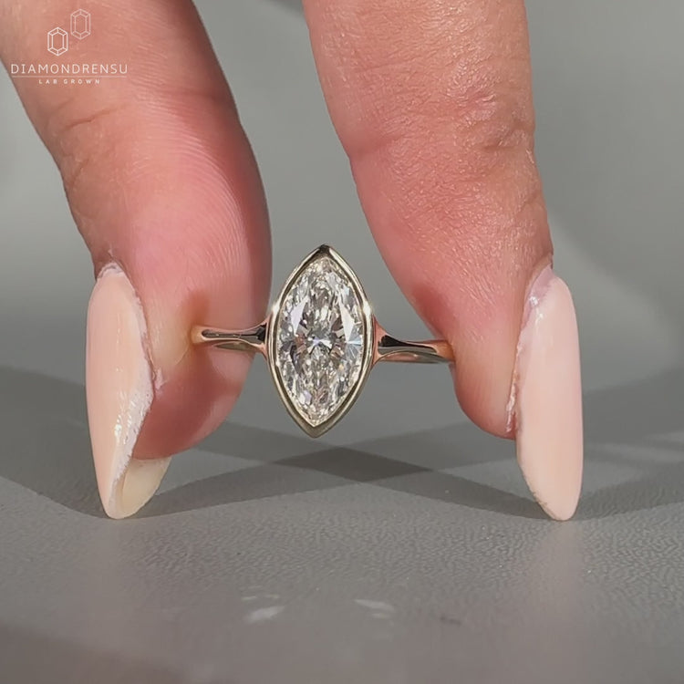 Marquise diamond ring bezel prong solitaire pinch shank.
