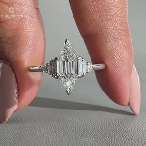 muse setting ring featuring round with baguette side stones.
