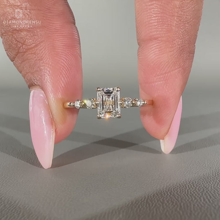 5 Stone Diamond Ring featuring a lab grown emerald cut center.
