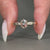 6 claw prong setting holds round cut side stone.
