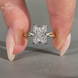 Handmade radiant cut diamond ring with four claw prong setting.
