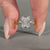 Handmade radiant cut diamond ring with four claw prong setting.
