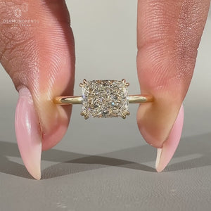 East west engagement ring with hidden halo and cushion cut diamond.
