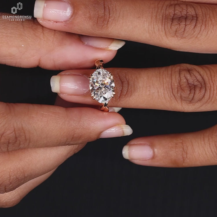 Oval diamond ring in yellow gold setting.
