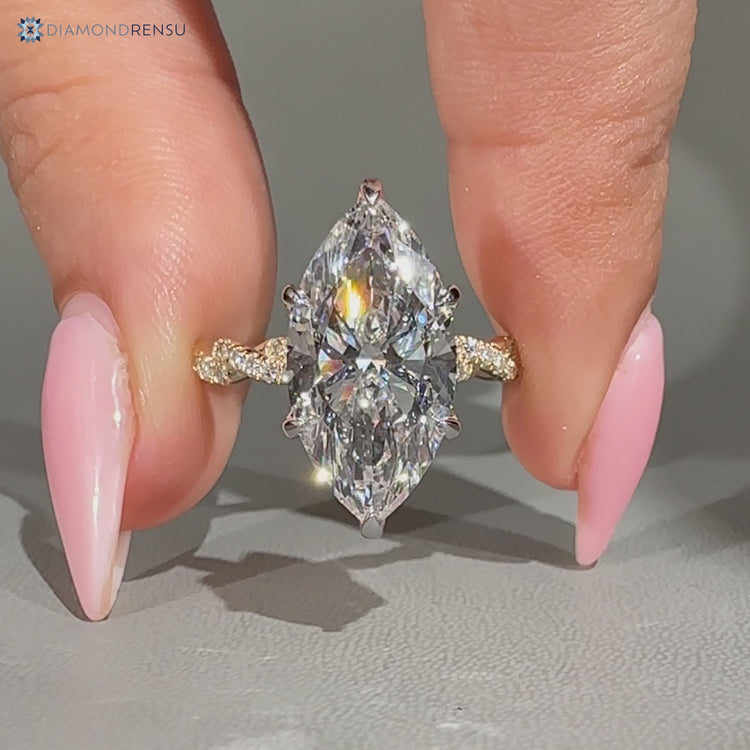 Two tone marquise diamond ring with twisted shank.