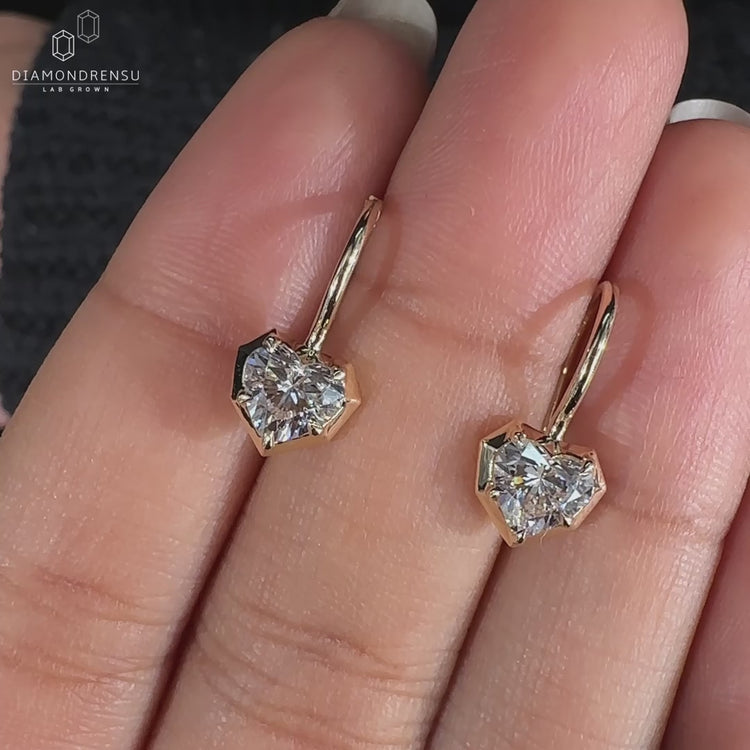 Heart shape diamond earrings with claw prong setting.
